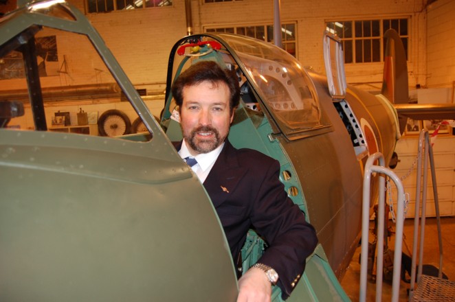Artist Steve Harper the Honorary Patron of Shuttleworth in the beautifully restored cockpit of the Mk 5 c Spitfire at Shuttleworth
